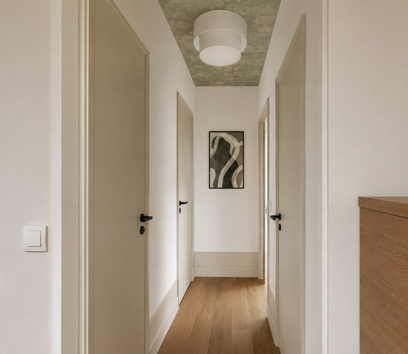 couloir avec papier peint au plafond et plinthes hautes moulurées
